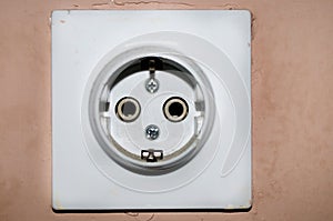 White European 220V power socket on green wall