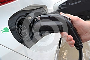 White EV,  electric vehicle being recharged