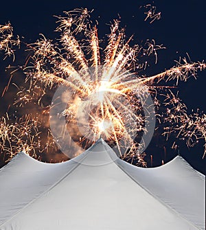 White events tent beneath fireworks