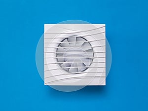 White exhaust fan on a bright blue background.