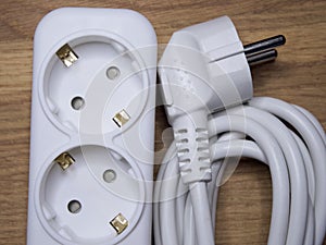 White extension cable with socket and plug, close-up