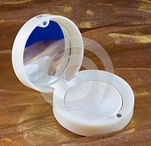 White eye shadow in mirror container