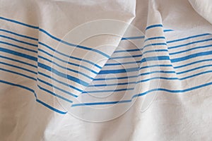 White fabric sheets in the hospital with stripes as background wrinkled