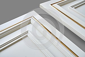 White facade panels with golden moulding isolated on gray background