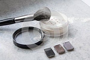 Face powder and brush on white background photo