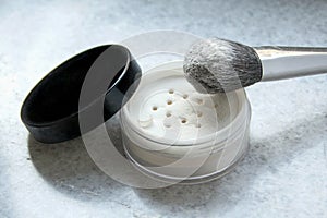 Face powder and brush on white background photo