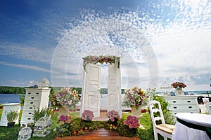 White fancy door as a wedding arch