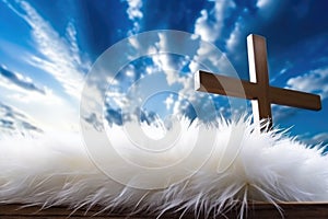 white feather and wooden cross on the backdrop of vibrant sky