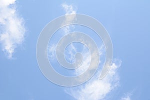 White feathery clouds on blue sky