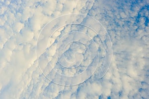 White feathery clouds in the blue sky