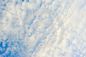 white feathery clouds in the blue sky