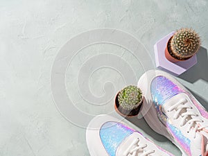 White female pastel sneakers with cactus on turquoise background