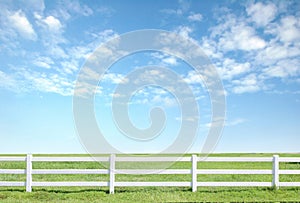 White fence on green grass