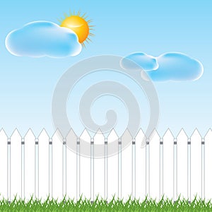 White fence and green grass on blue sky background