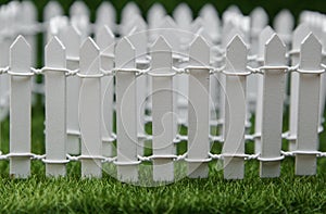 White fence and green lawn