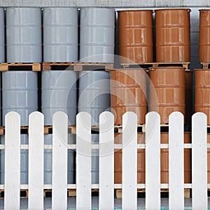 White fence that separates the area of the storage tanks.