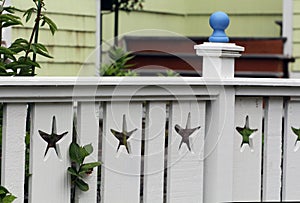 White fence with starfish cut outs and arbor at coast