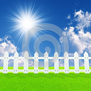 White fence on a summer lawn