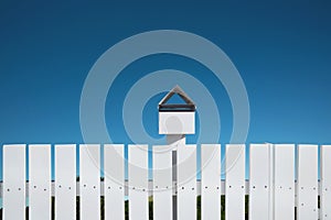 White fences with mailbox and blue sky, Clipping path