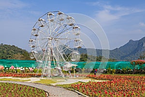 A white ferris wheel with blue sky