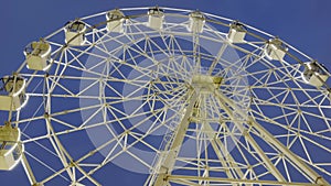 White Ferris wheel at night withs lights with round rotation.