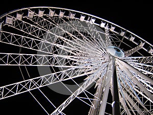 White Ferris Wheel over dark night sky