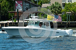 White, fiberglass boat, powered by four 300 HP outboard motors