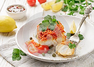White fish cod, Pollock, nototenia, hake, braised with onions, carrots and tomatoes