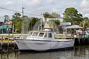 White fishing boat at dock