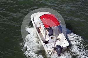 White Fishing Boat with Red Canvas Canopy