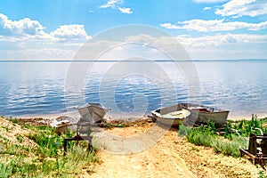 White fishing boat rest on shore. old rusty winch and boat on beach. beautiful summer landscape