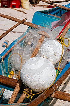 White fishing nets in the blue boat on the beach