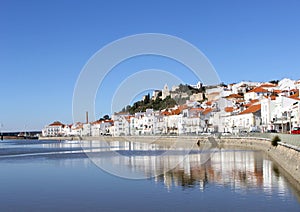 White fishing village castle river water reflections, Alentejo, Portugal