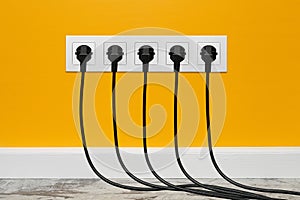 White five-way wall power socket on yellow wall