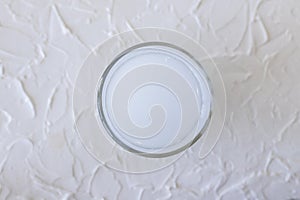 White fizzy vitamin supplement dissolved in a glass of water, top view