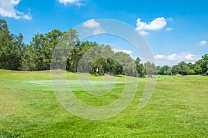 White flag with blue sky in golf course green grass