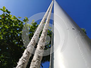 White flagpole with string on the left side