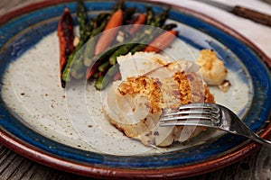 White flakey sea bass with breadcrumbs and roasted asparagus and