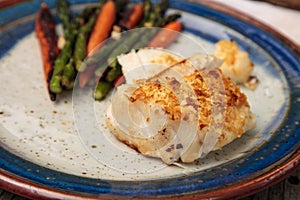 White flakey sea bass with breadcrumbs and roasted asparagus and