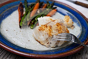 White flakey sea bass with breadcrumbs and roasted asparagus and