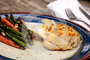 White flakey sea bass with breadcrumbs and roasted asparagus and