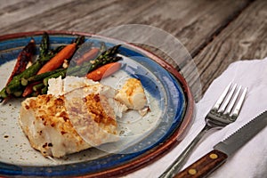 White flakey sea bass with breadcrumbs and roasted asparagus and