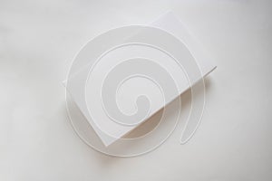 White flat cardboard box highlighted on a white background with a shadow