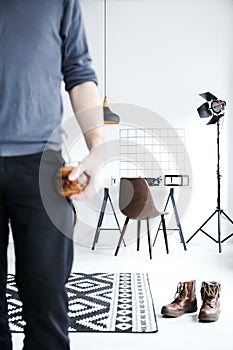 White flat with studio lamp and man holding yerba mate cup