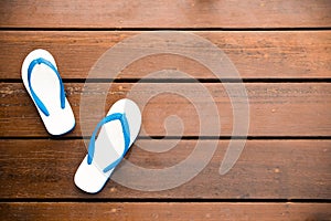 White Flipflops on a wood background