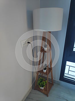 White Floor lamp with lampshade for lighting the room.