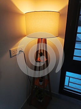 White Floor lamp with lampshade for lighting the room.