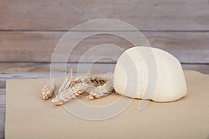 A white flour bun and a few ripe wheat ears