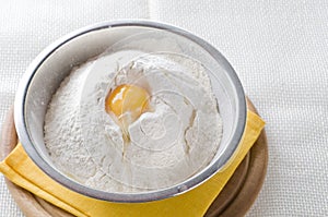 White flour and egg in bowl