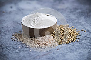 White flour Thai in wooden bowl with white rice Thai and rice ears isolated on tone background, Food and baking ingredient